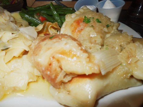 Pierogis with a side of noodles and cabbage.