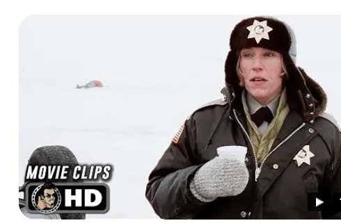 A police officer wearing a winter uniform and hat holds a cup in a snowy landscape, with an unidentified figure lying in the distance.